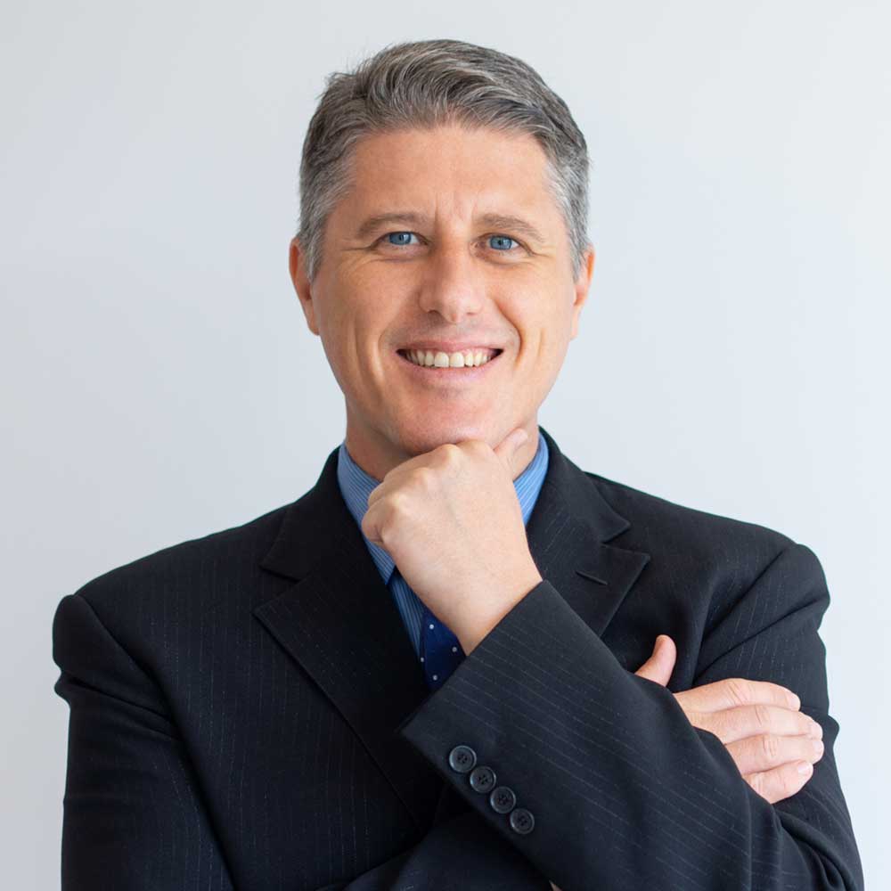 Smiling man in a suit with thoughtful pose.