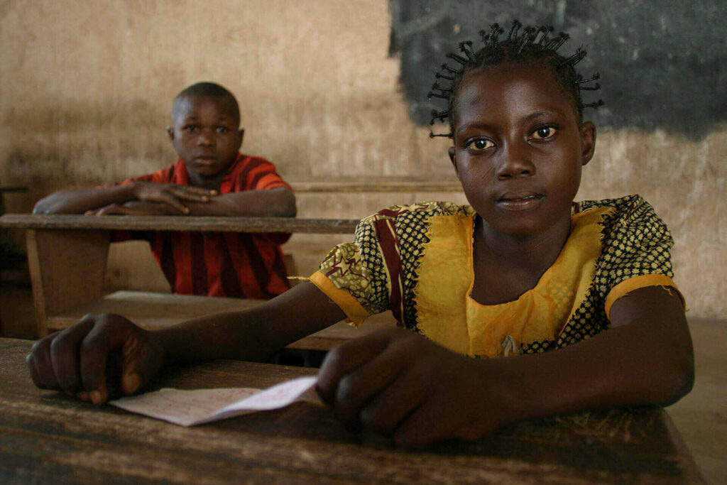 Children sitting at desks in a classroom.