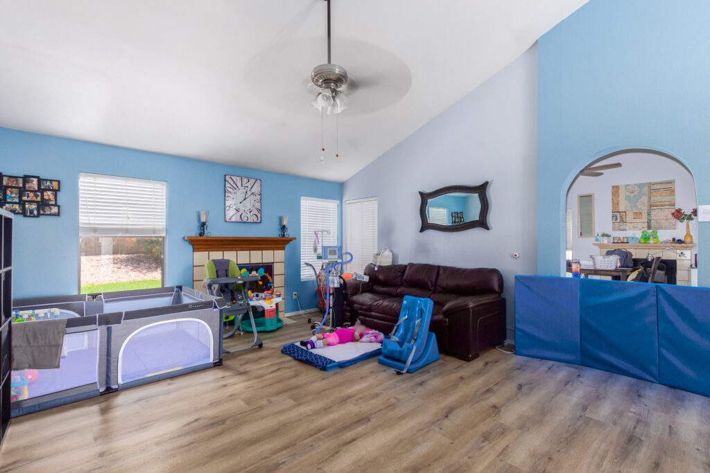 Cozy living room with baby gear.