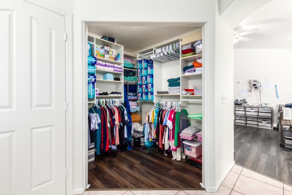 Organized closet with clothes and supplies.